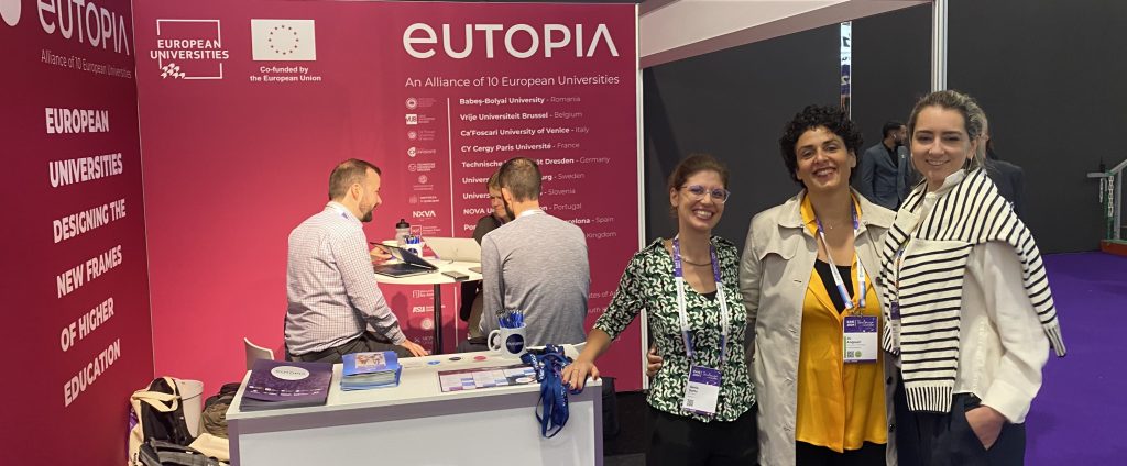 People working for EUTOPIA smiling in front of the Alliance's booth at the EAIE conference, Toulouse, 2024